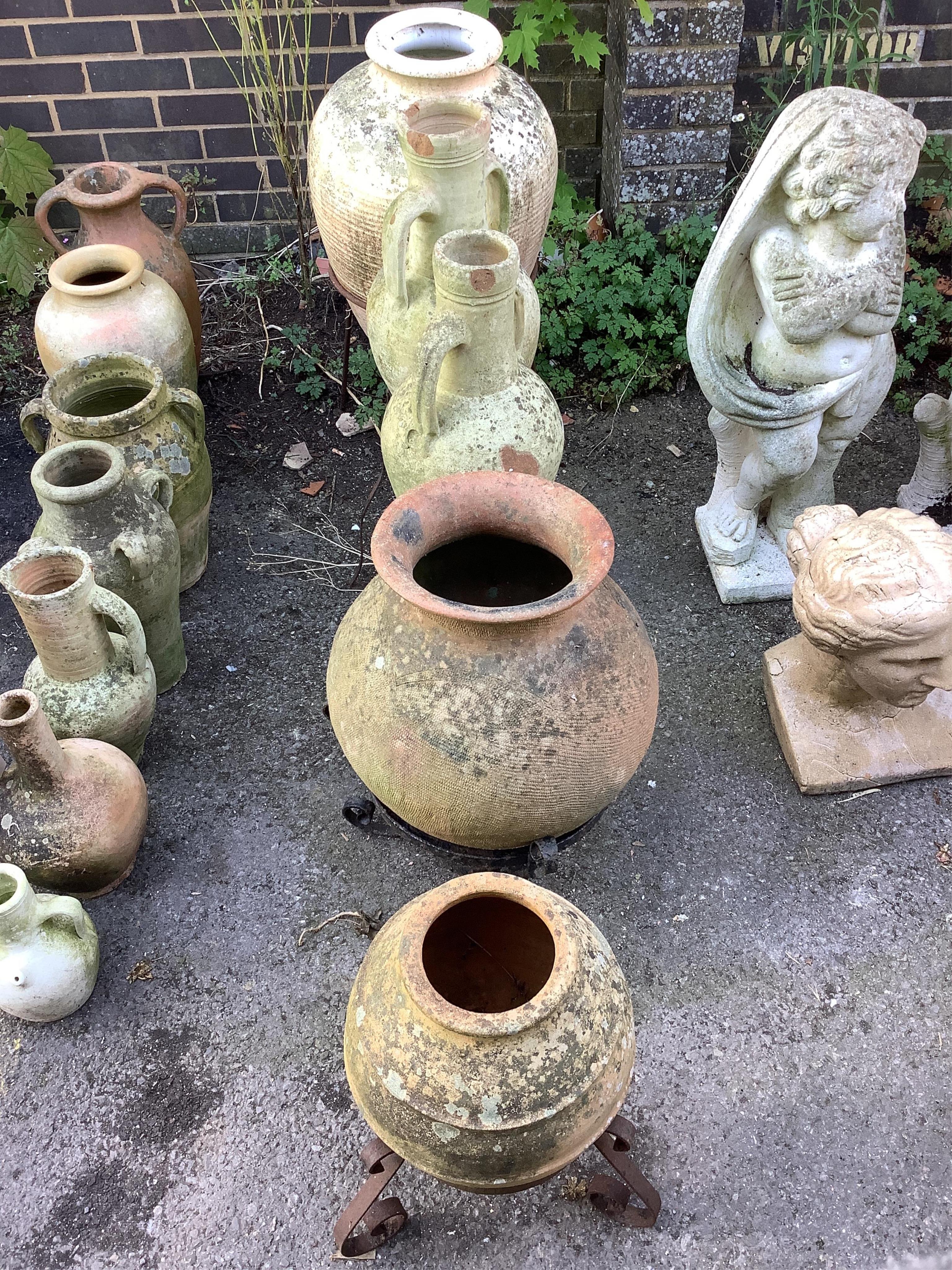 Five earthenware amphora on wrought iron stands, largest height 80cm. Condition - poor to fair